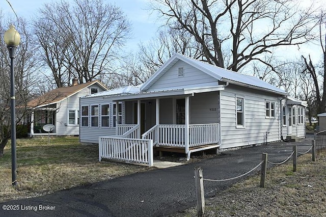 view of front of house with covered porch and metal roof