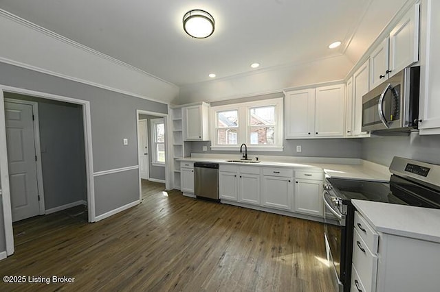 kitchen featuring stainless steel appliances, white cabinets, dark wood finished floors, and light countertops