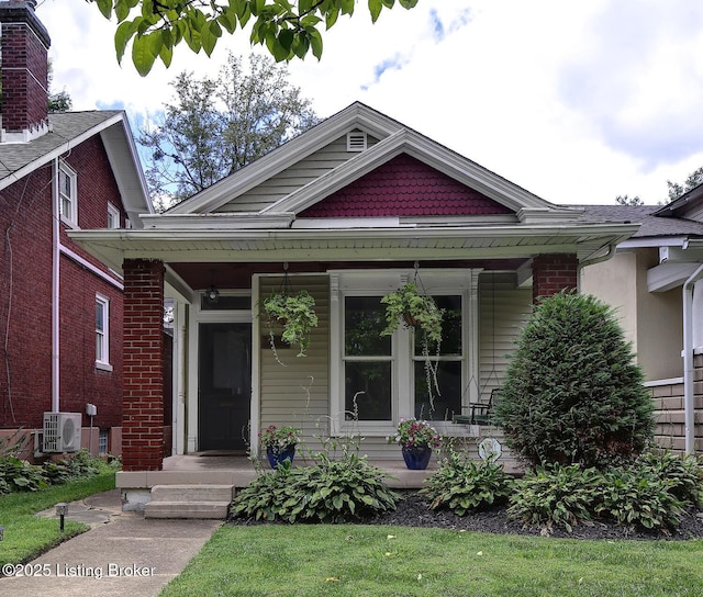 bungalow-style house featuring a porch and ac unit