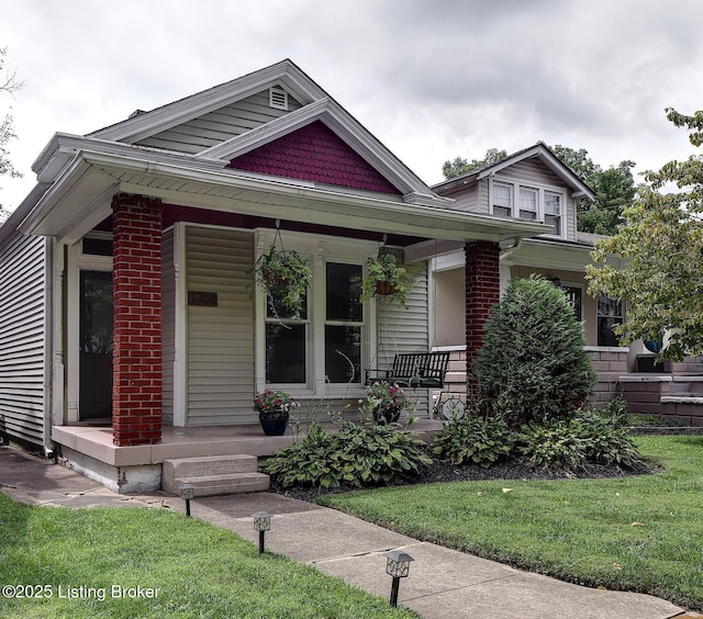 view of front of house with brick siding and covered porch