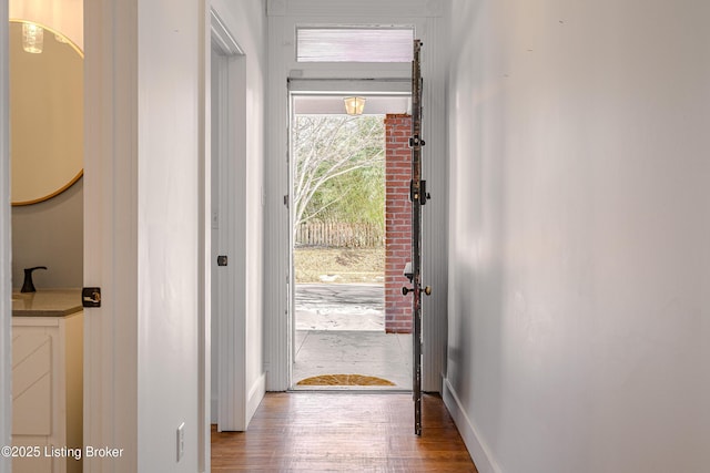 entryway with wood finished floors and baseboards