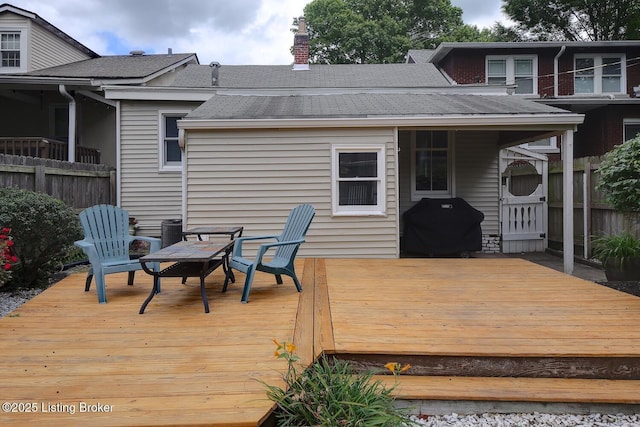 wooden terrace featuring grilling area and fence