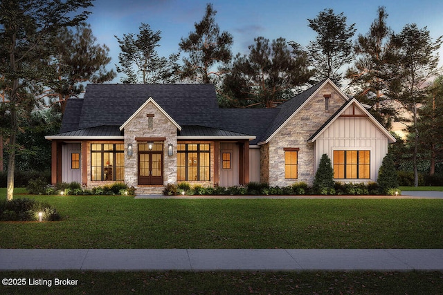 modern farmhouse featuring board and batten siding, a front yard, a standing seam roof, and stone siding