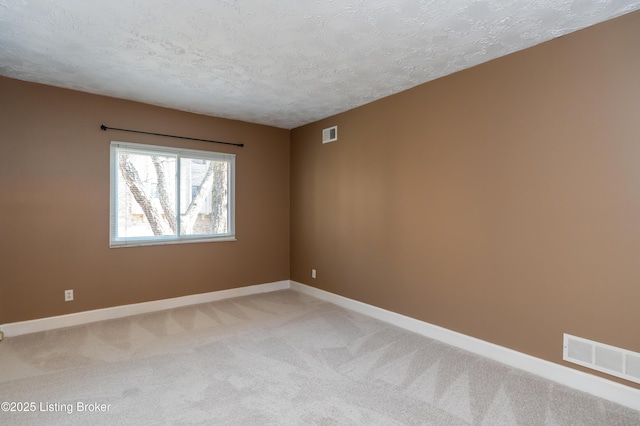 5800 Coach Gate Wynde Unit 295B, Louisville, KY 40207 - unfurnished room with visible vents, baseboards, light colored carpet, and a textured ceiling