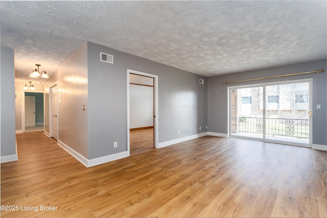 5800 Coach Gate Wynde Unit 295B, Louisville, KY 40207 - empty room featuring baseboards, visible vents, light wood-type flooring, and a textured ceiling