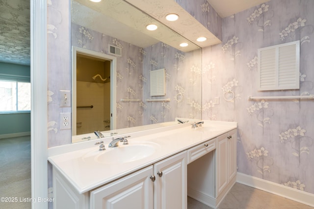 5800 Coach Gate Wynde Unit 295B, Louisville, KY 40207 - bathroom featuring wallpapered walls, double vanity, baseboards, and a sink