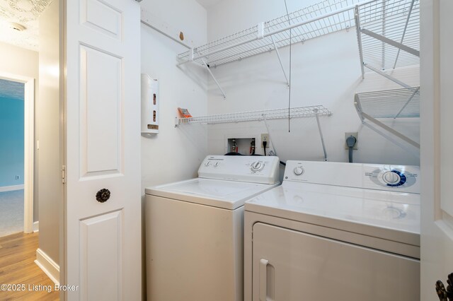 5800 Coach Gate Wynde Unit 295B, Louisville, KY 40207 - washroom with baseboards, light wood-style flooring, laundry area, and washer and clothes dryer