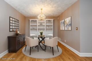 5800 Coach Gate Wynde Unit 295B, Louisville, KY 40207 - dining room featuring baseboards, a notable chandelier, and wood finished floors