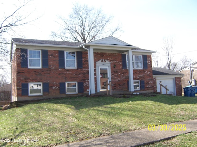 split foyer home with a front yard and brick siding