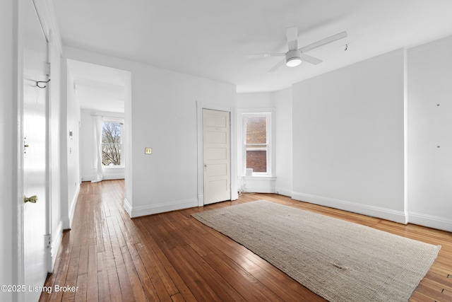 unfurnished bedroom with ceiling fan, baseboards, and wood-type flooring