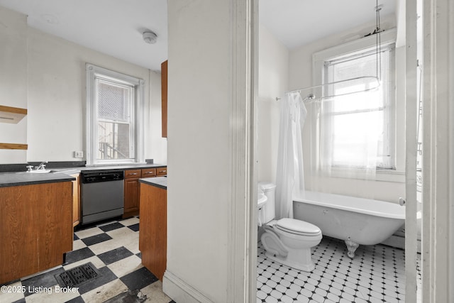 bathroom featuring vanity, tile patterned floors, toilet, and a healthy amount of sunlight