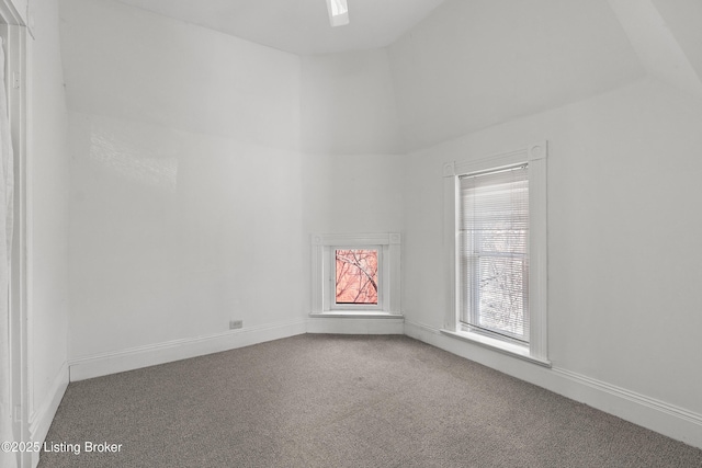 unfurnished room with vaulted ceiling and carpet floors