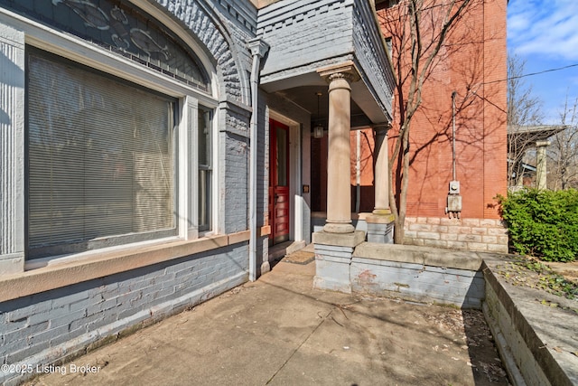 doorway to property with brick siding