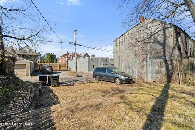 view of yard with an outbuilding and fence