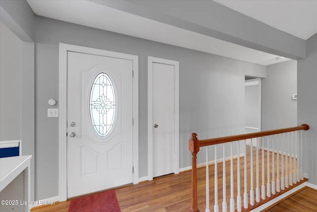 entrance foyer with baseboards and light wood-style flooring