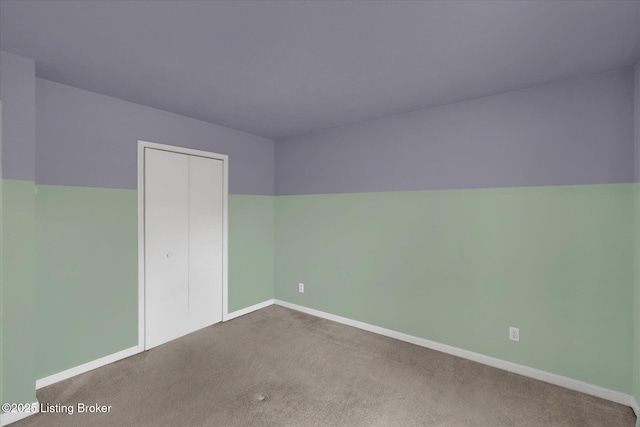 unfurnished bedroom with a closet, baseboards, and carpet