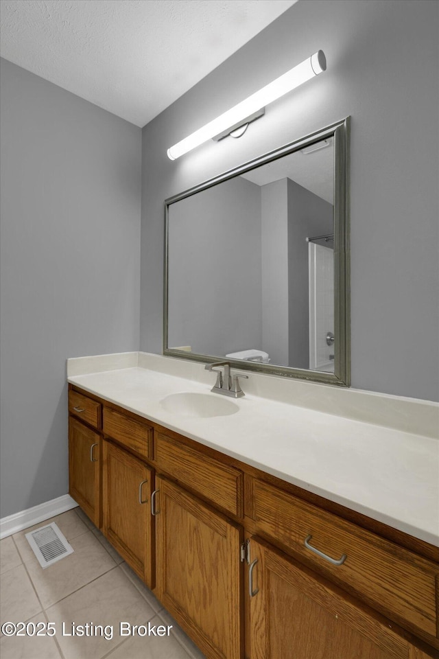 bathroom featuring tile patterned flooring, vanity, and visible vents