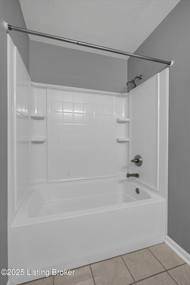 bathroom featuring tile patterned floors, a textured ceiling, and shower / bath combination