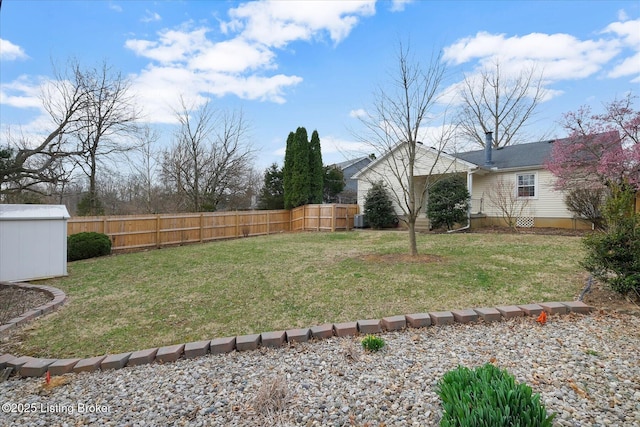 view of yard featuring a fenced backyard, a storage unit, and an outdoor structure