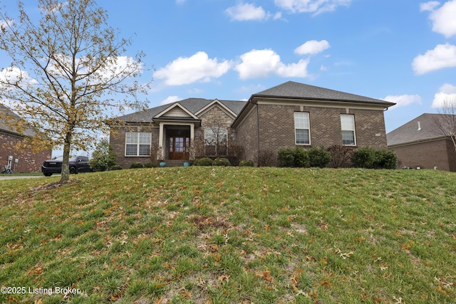 view of front of house featuring brick siding and a front lawn