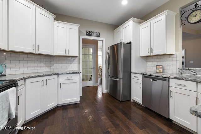 kitchen with white cabinetry, light stone counters, dark wood-style floors, and appliances with stainless steel finishes