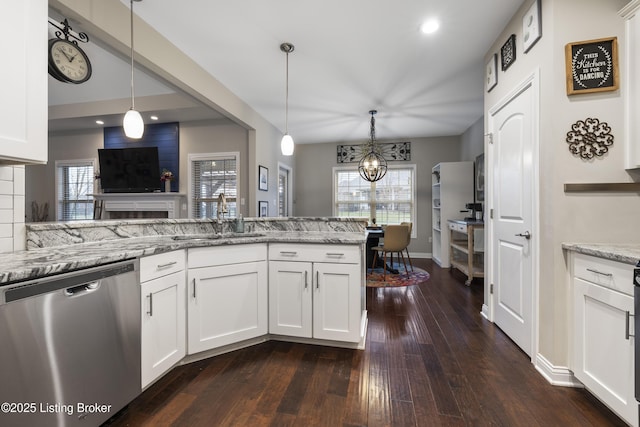 kitchen with a sink, light stone counters, white cabinets, dishwasher, and a healthy amount of sunlight