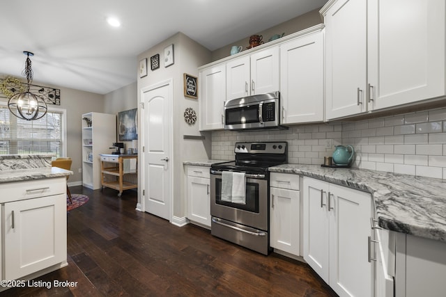 kitchen with dark wood-style floors, white cabinetry, and stainless steel appliances