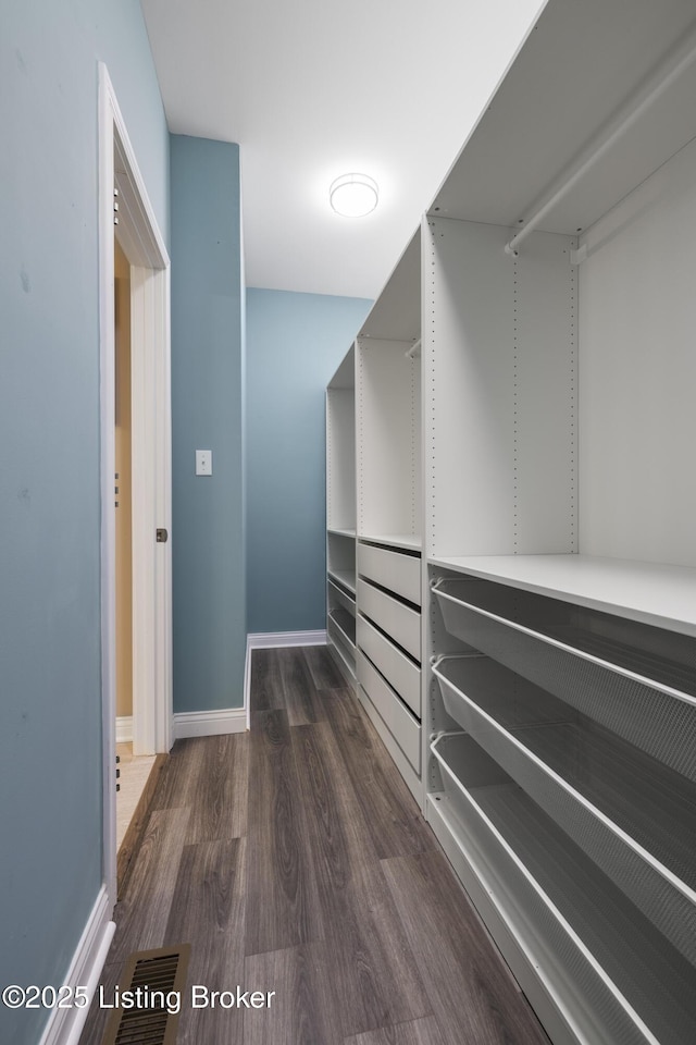 spacious closet featuring dark wood-style floors and visible vents