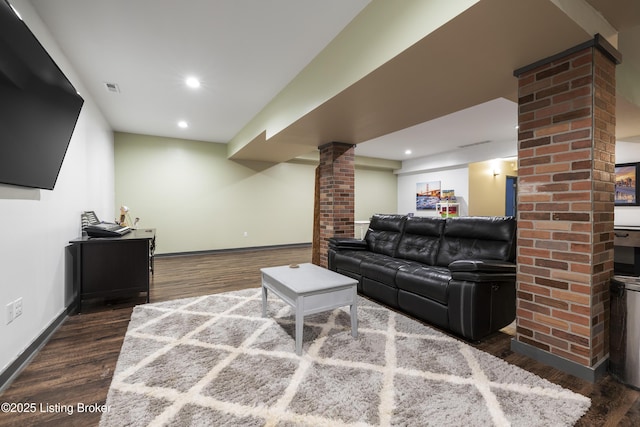 living room featuring wood finished floors, visible vents, ornate columns, baseboards, and recessed lighting