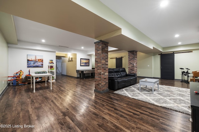 living area featuring baseboards, a barn door, decorative columns, recessed lighting, and wood finished floors