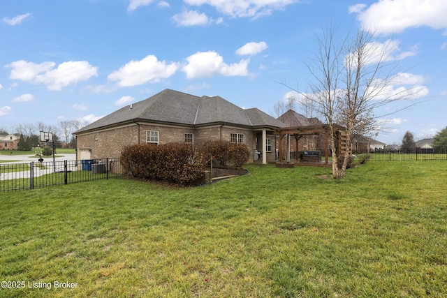 back of house with brick siding, a yard, a pergola, and a fenced backyard