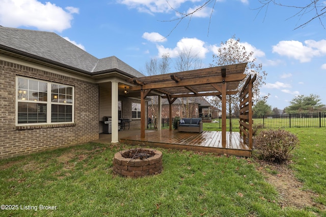 view of yard featuring a deck, fence, a fire pit, and a pergola