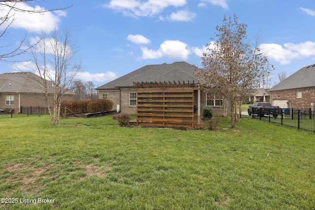 back of house with brick siding, a lawn, a pergola, and a fenced backyard