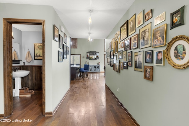 hall with baseboards and dark wood-style flooring