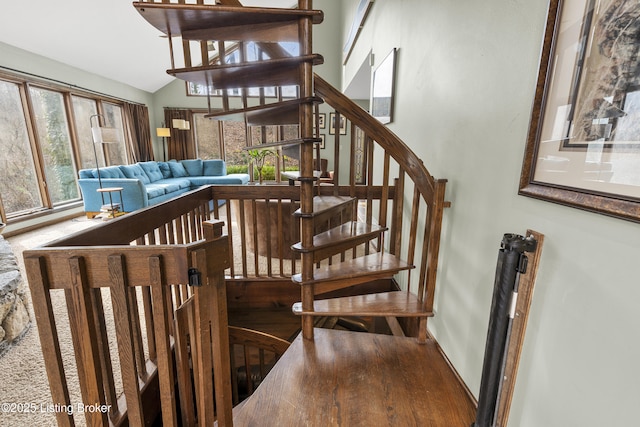 stairs with vaulted ceiling