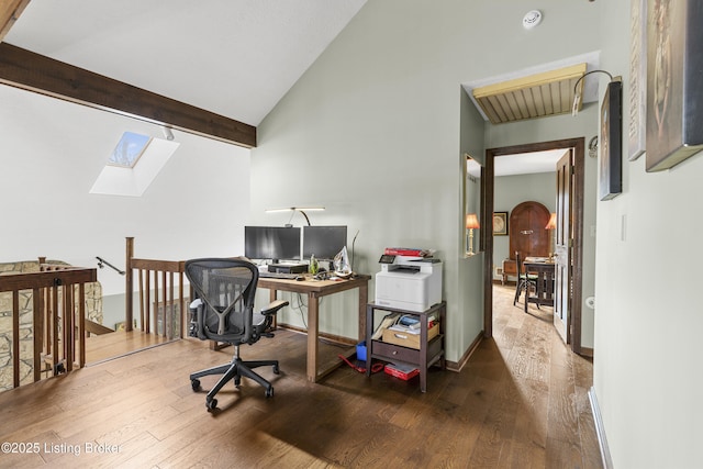 office featuring wood finished floors, baseboards, high vaulted ceiling, beam ceiling, and a skylight