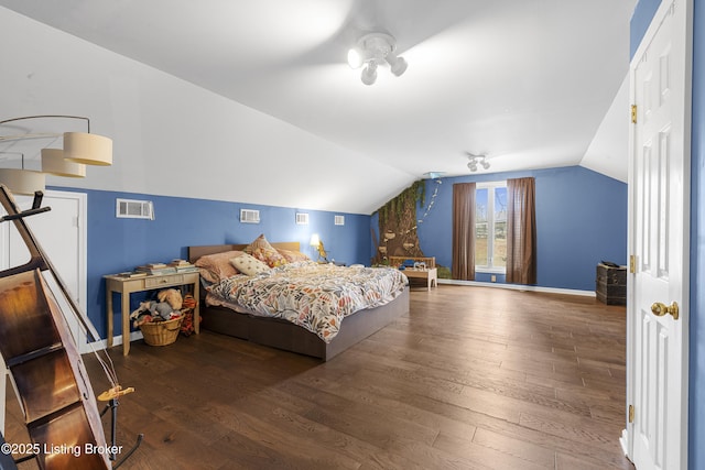 bedroom featuring lofted ceiling, wood finished floors, and visible vents