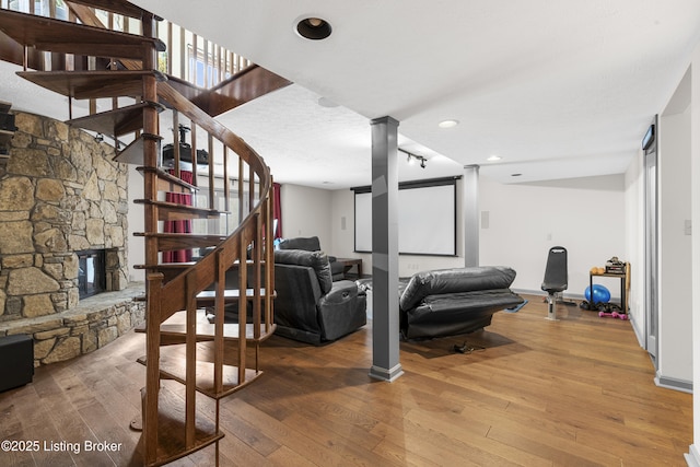 interior space featuring stairs, hardwood / wood-style flooring, a fireplace, and baseboards