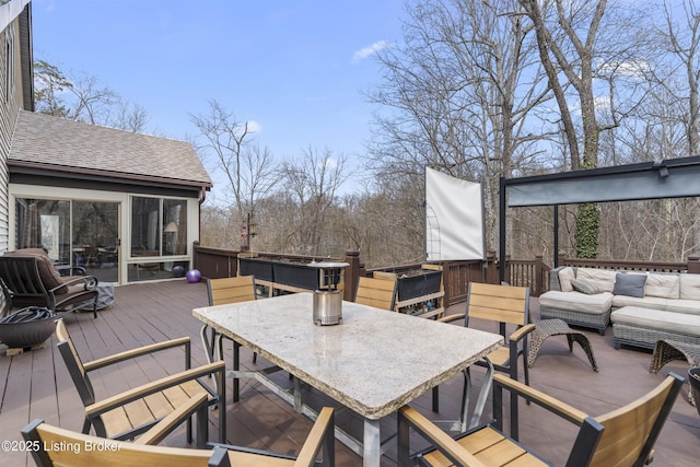 wooden deck with an outdoor living space and outdoor dining area