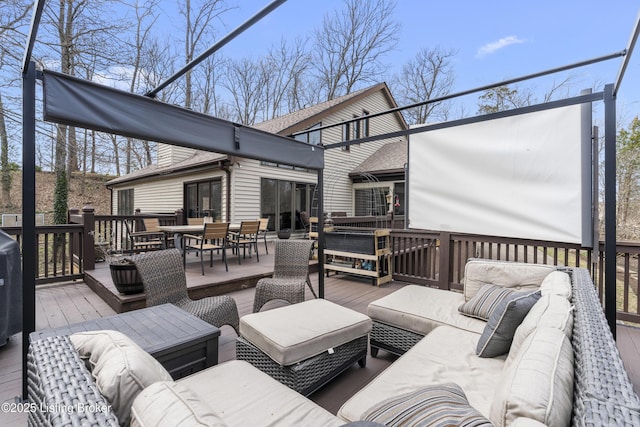 wooden terrace with an outdoor hangout area and outdoor dining space