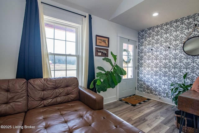 foyer entrance featuring recessed lighting, wallpapered walls, baseboards, and wood finished floors