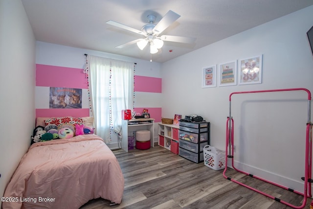 bedroom featuring baseboards, a ceiling fan, and wood finished floors