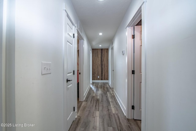 hall with recessed lighting, baseboards, and wood finished floors