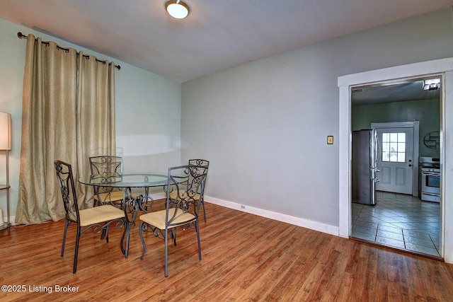 dining room featuring wood finished floors and baseboards