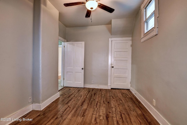 unfurnished bedroom with ceiling fan, baseboards, and wood finished floors