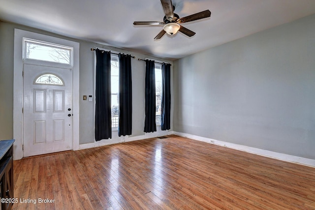 entryway featuring visible vents, plenty of natural light, light wood-style flooring, and a ceiling fan