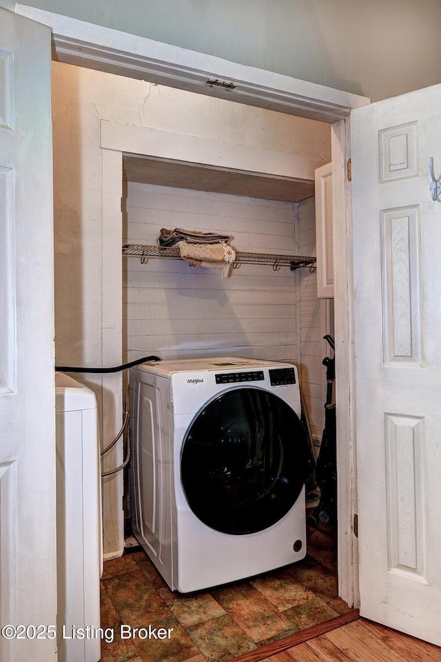 clothes washing area featuring laundry area and washing machine and clothes dryer