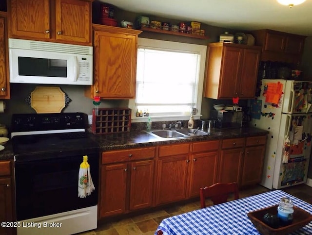 kitchen with white microwave, dark countertops, black range with electric stovetop, and a sink