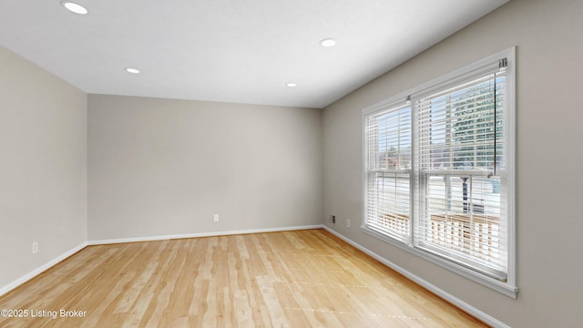 unfurnished room with recessed lighting, baseboards, and wood finished floors