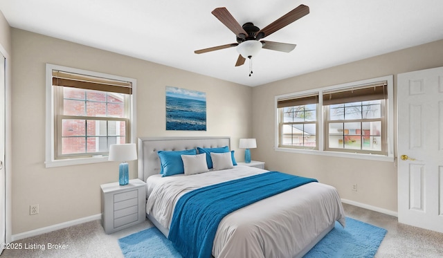 bedroom with a ceiling fan, baseboards, and carpet floors